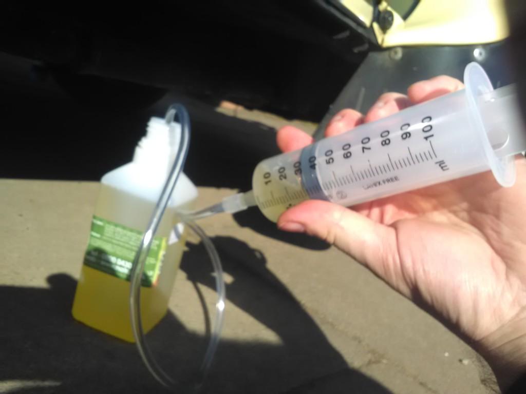 Filling a syringe with caster oil