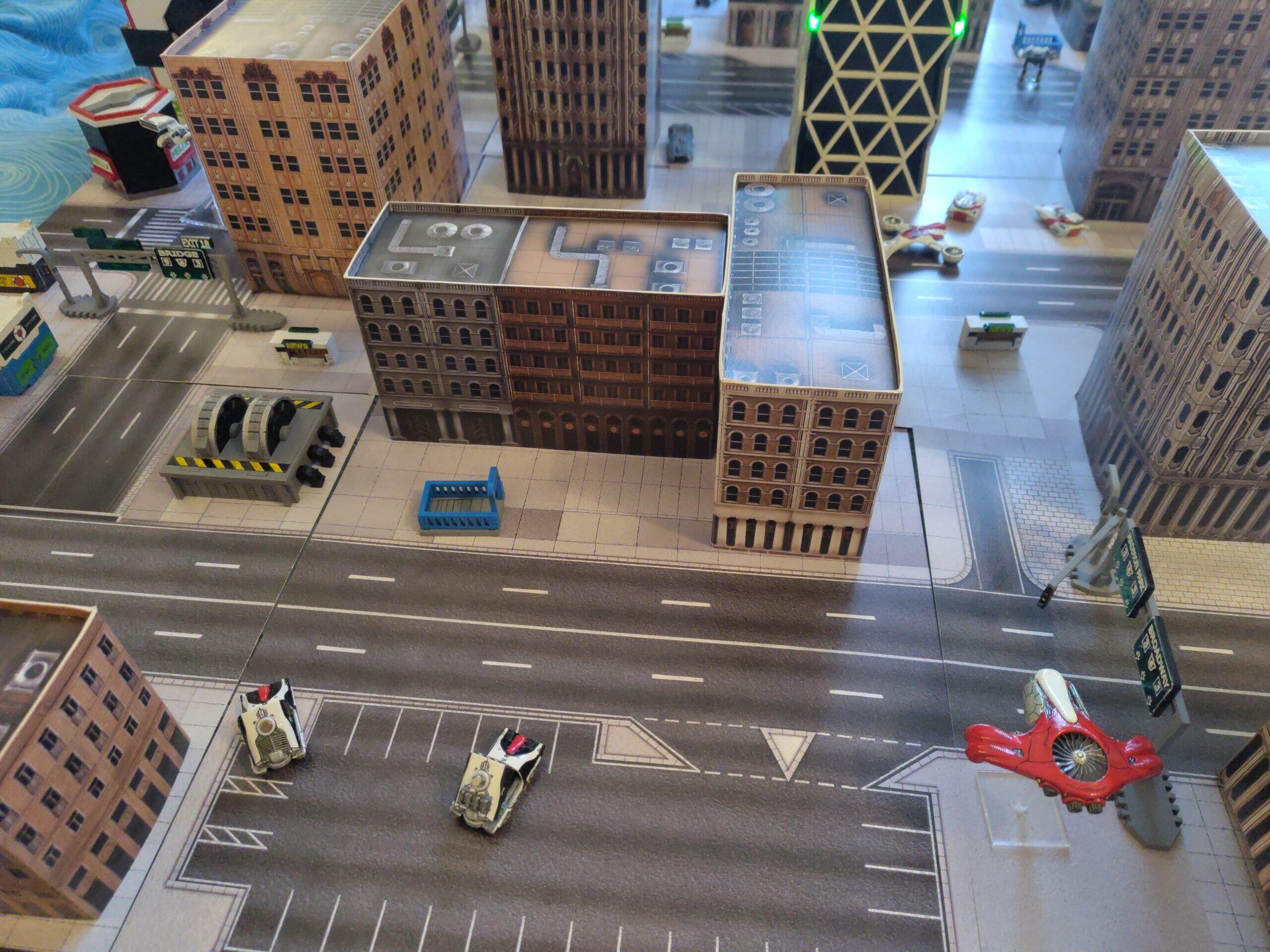 PHR Taranis Artillery Tanks provide fire support from the edge of the city with a Proteus Mobile Command Post nearby